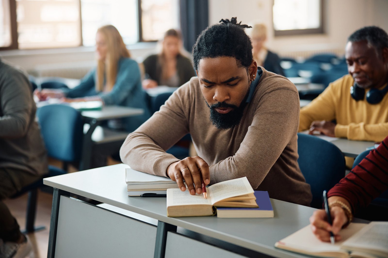 African American mid adult student learning on a class in lecture hall.